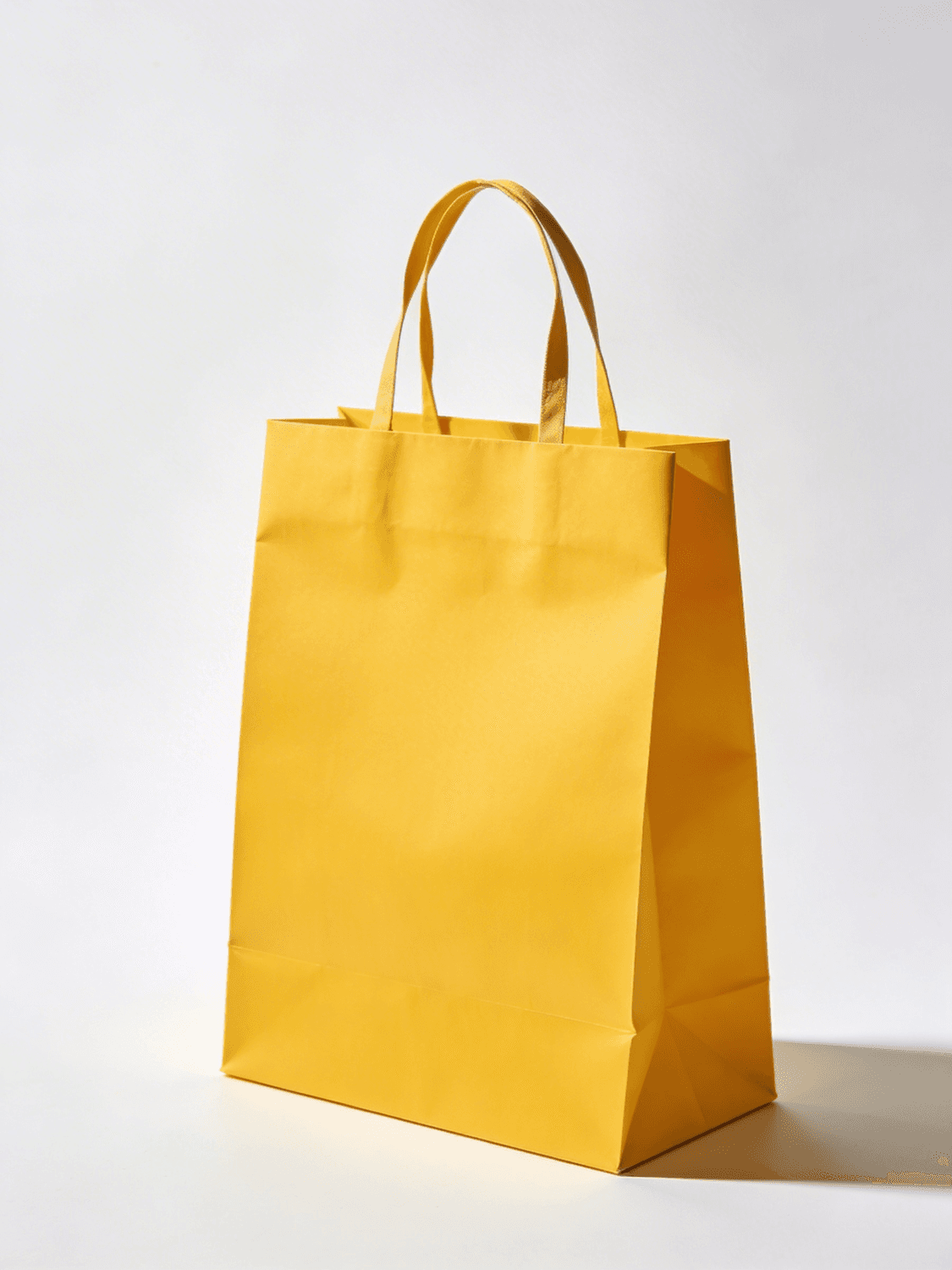 Bolsa de papel amarilla con asas de la panadería Horno Lento